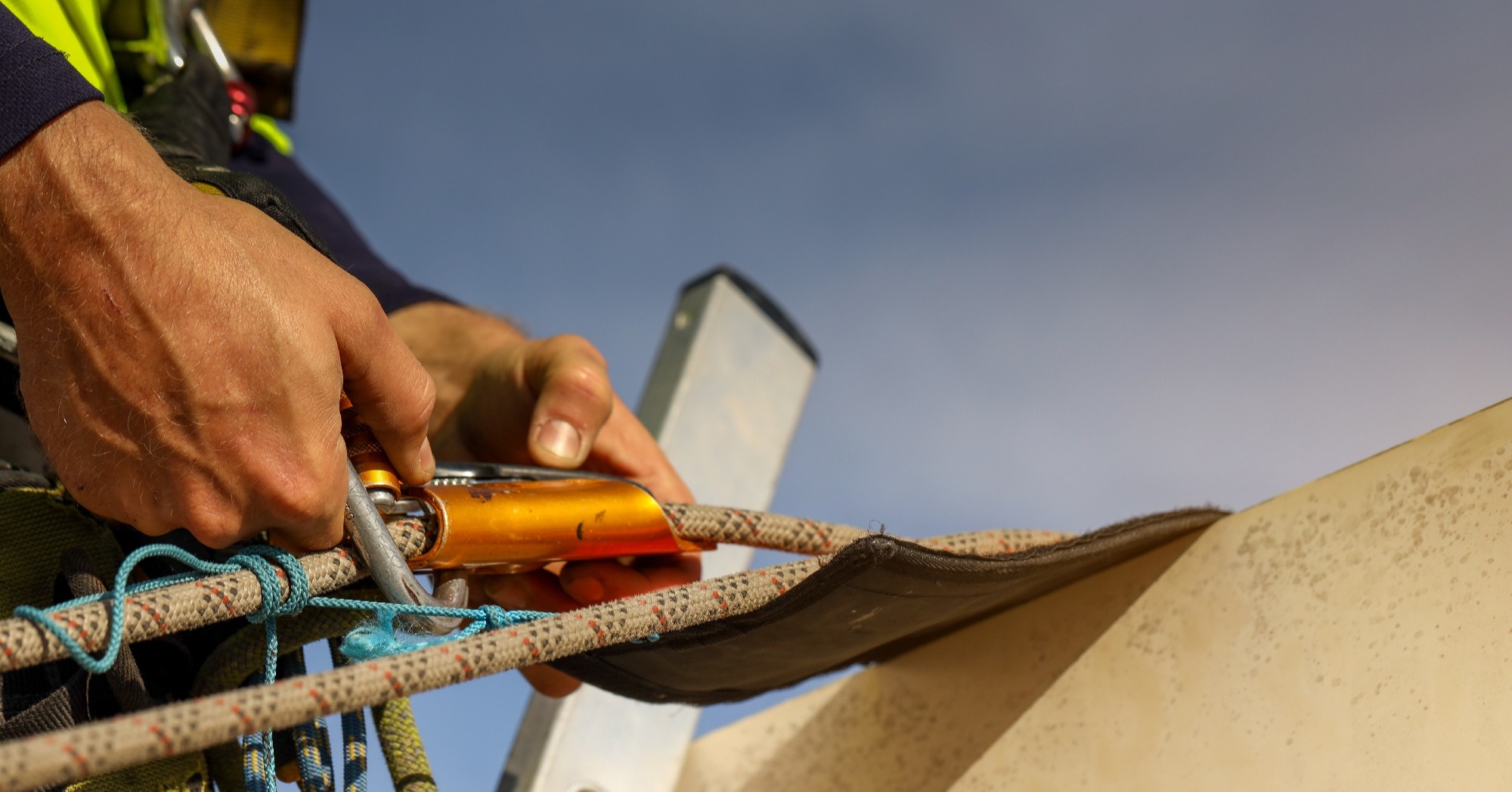 A man clipping in a ladder fall arrest system