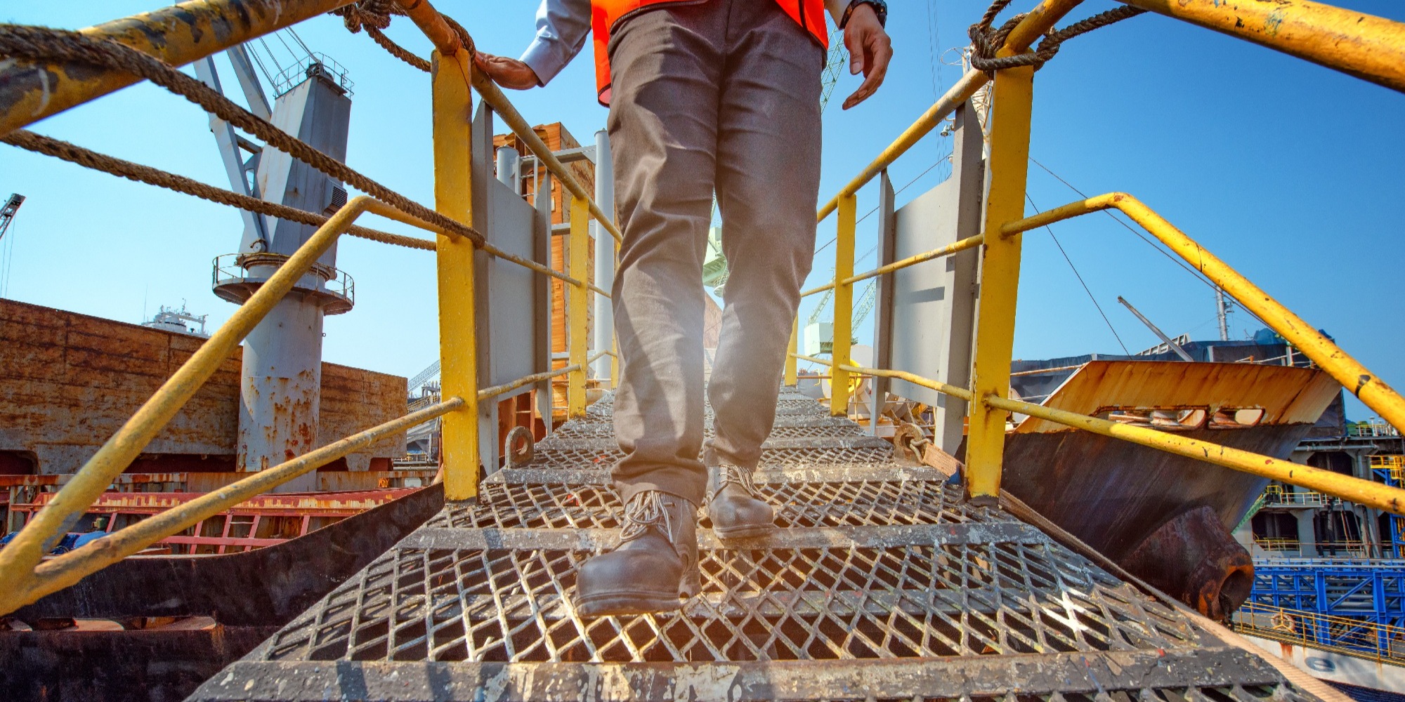 A man holding onto an aluminum handrail