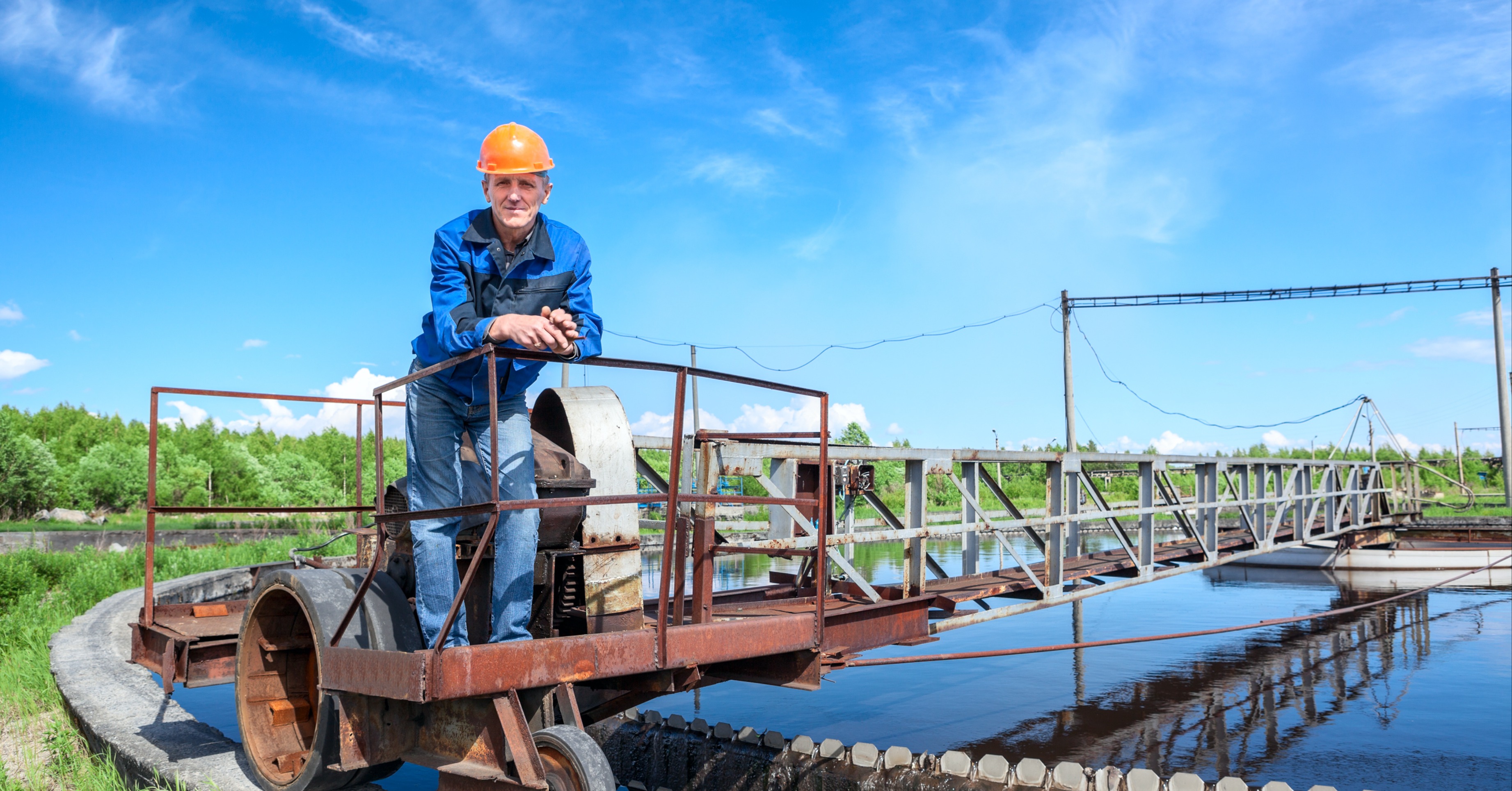 A man standing beside a walkway at a water treatment plant